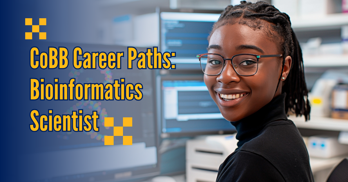 Bioinformatics Scientist bioinformatics scientist smiling at desk